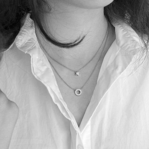 Lady wearing two silver necklace with different length. Silver star on 40cm length while Silver Brilliance Puck Hollow on 50cm length medical sensitive skin friendly nickel free