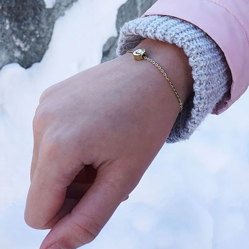 Lady on a winter trip wearing Gold Grand Bezel Bracelet on her right hand medical sensitive skin friendly nickel free